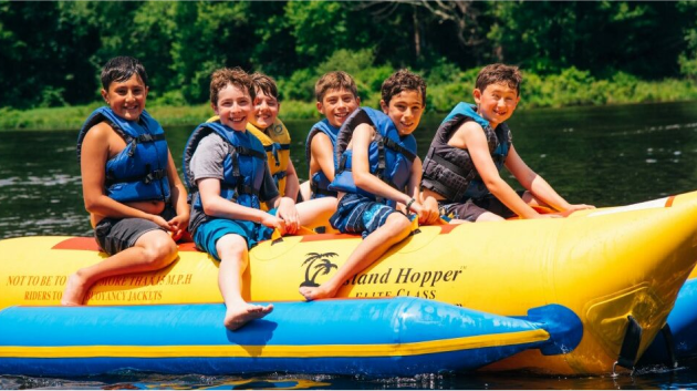 A group of campers on an inflatable boat.