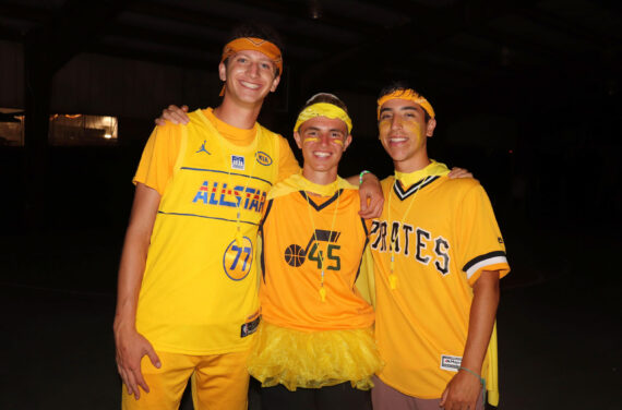 Three Camp Nesher staff members dressed in yellow.